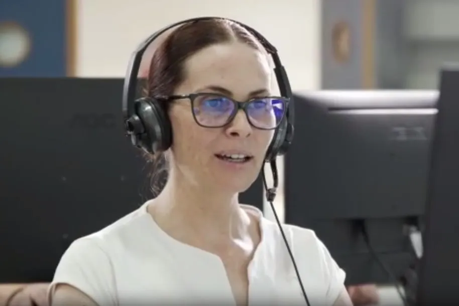 Mujer con auriculares trabajando en control de transporte